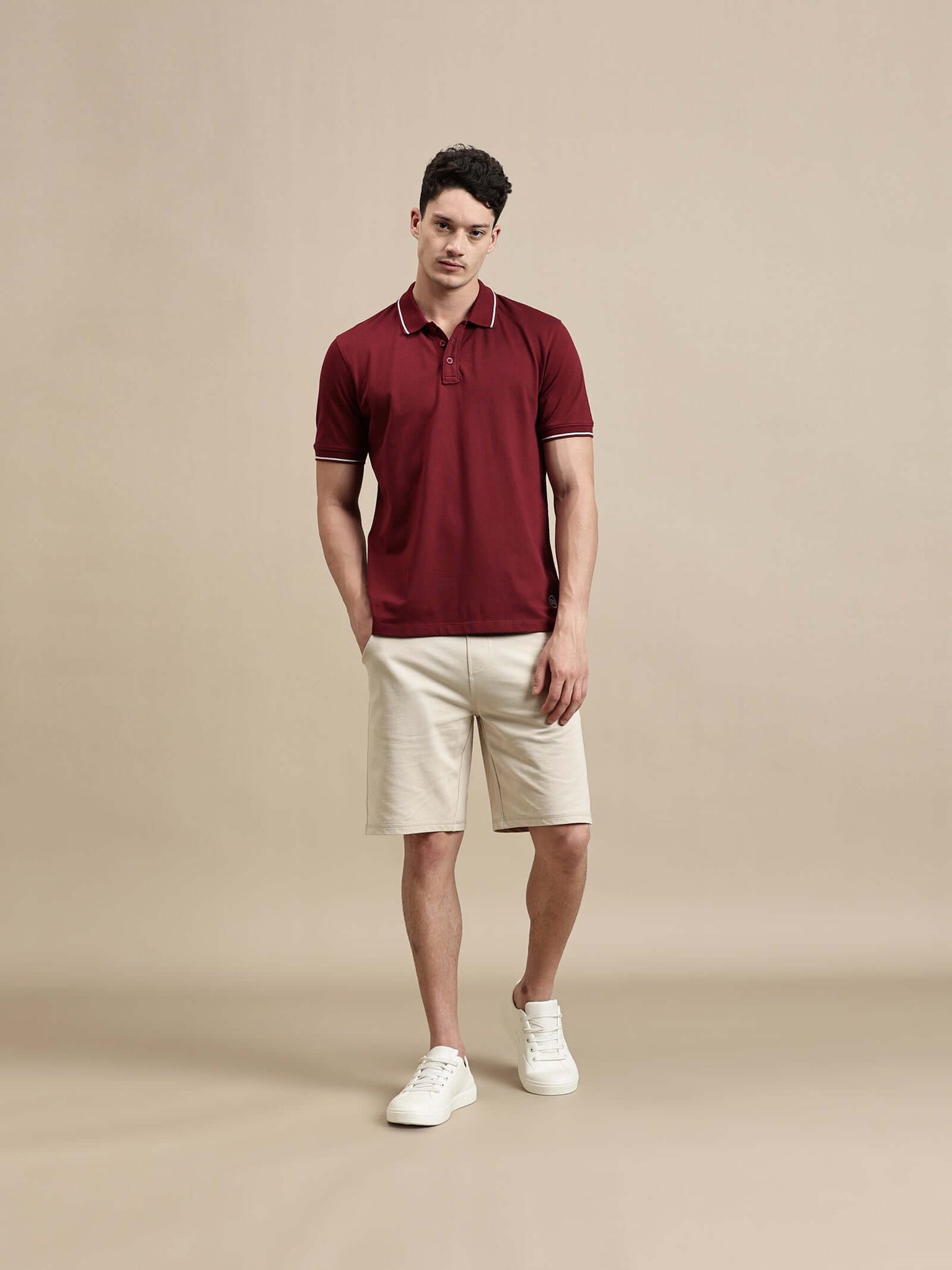 Men's Polo – Half Sleeve - Basic Polo With Tipping And Plating Slim Fit modeled by a man in a maroon color.
