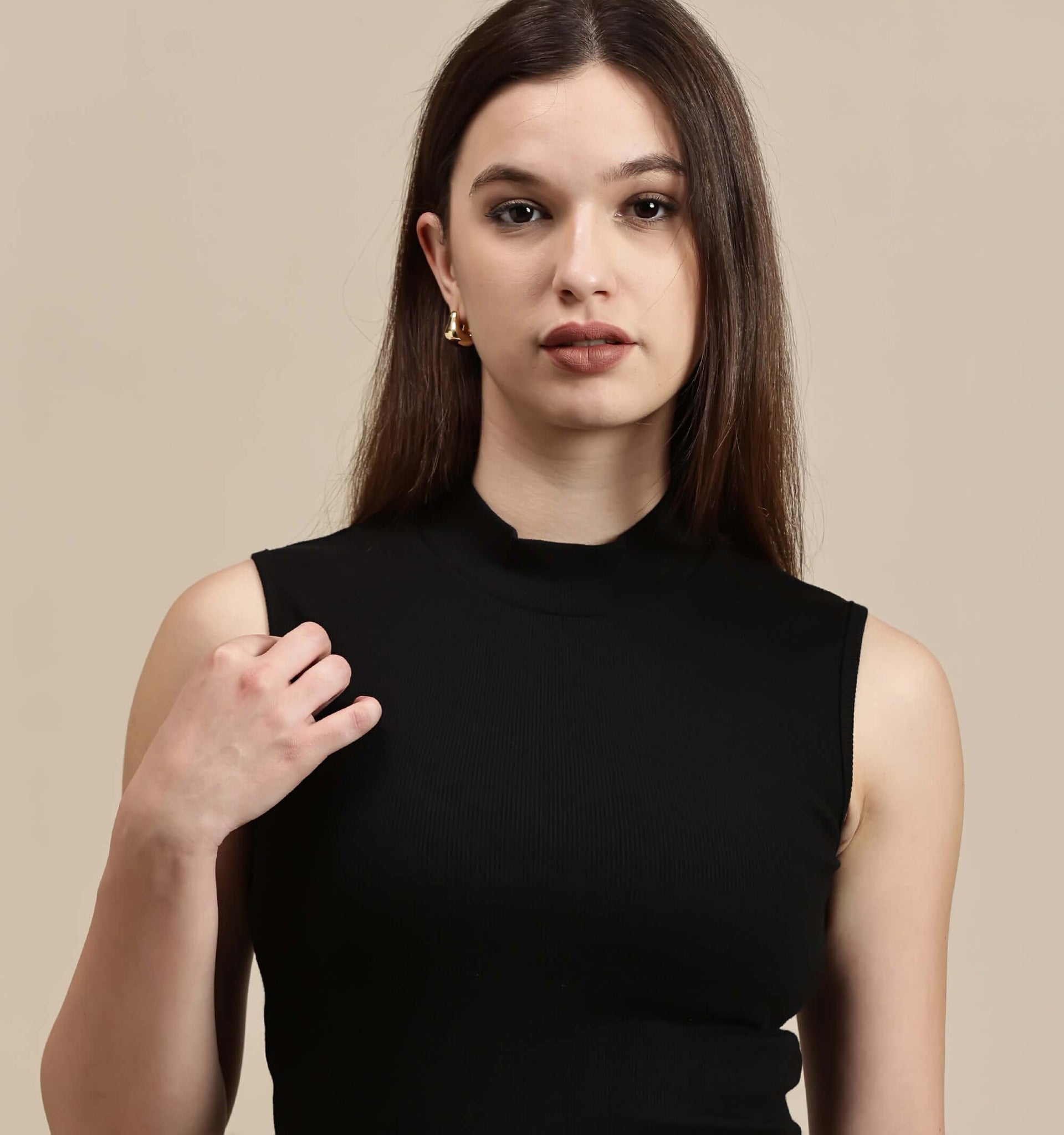 Women's Crop Top-High Neck Sleeveless Top worn by a model, showcasing a sleek black design and fitted style.